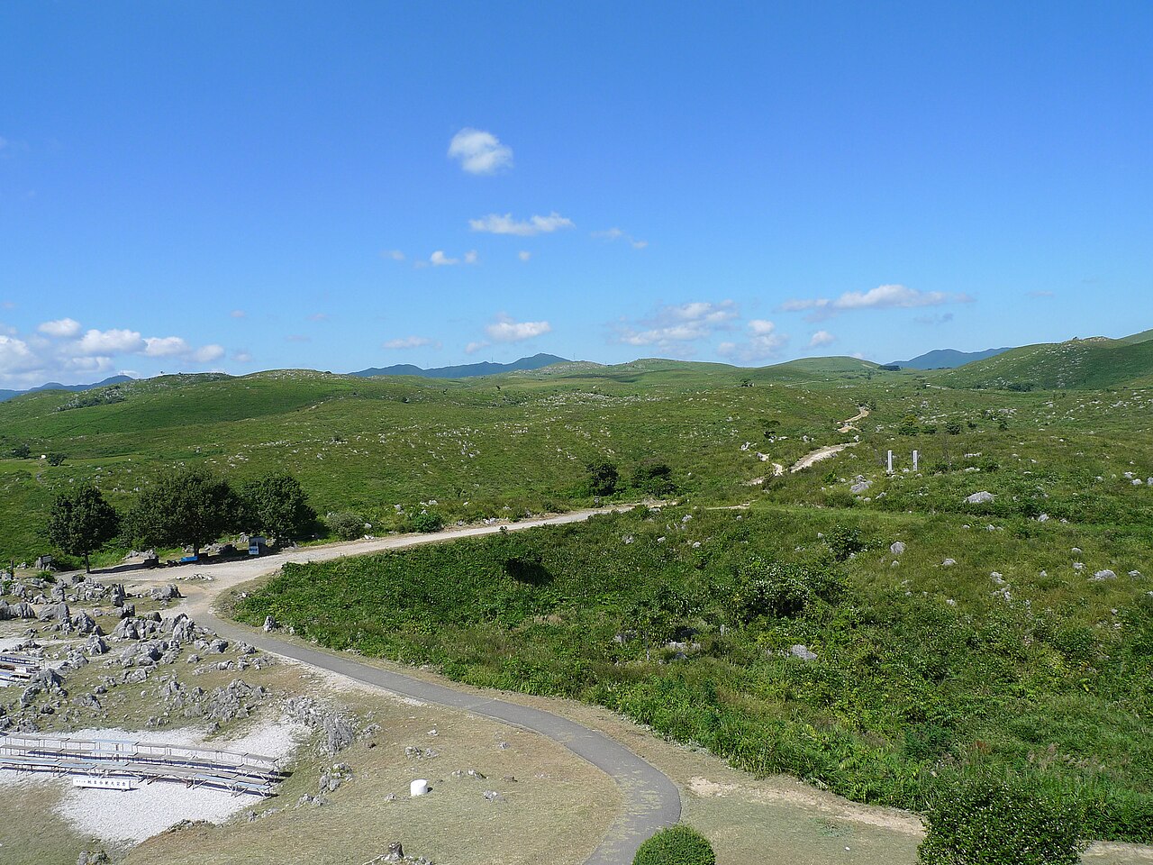 Green hills and exposed limestone at Akiyoshidai in a 2009 landscape photograph; regional context, not the newly described cave animal