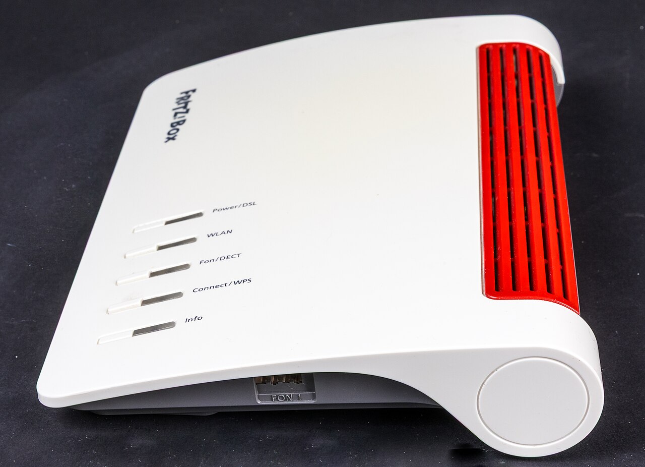 White and red FRITZ!Box 7590 router against a dark background; hardware context, not evidence of FRITZ!OS 8.50 availability for this model