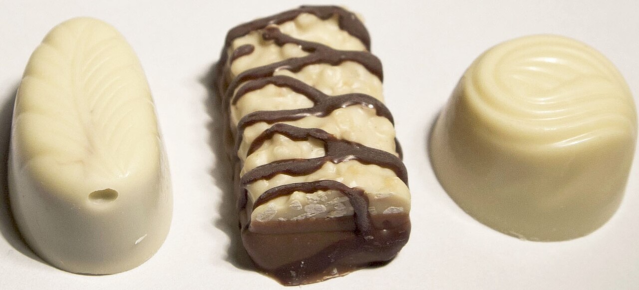 Three white chocolate confectionery pieces, a context photograph rather than the announced pie